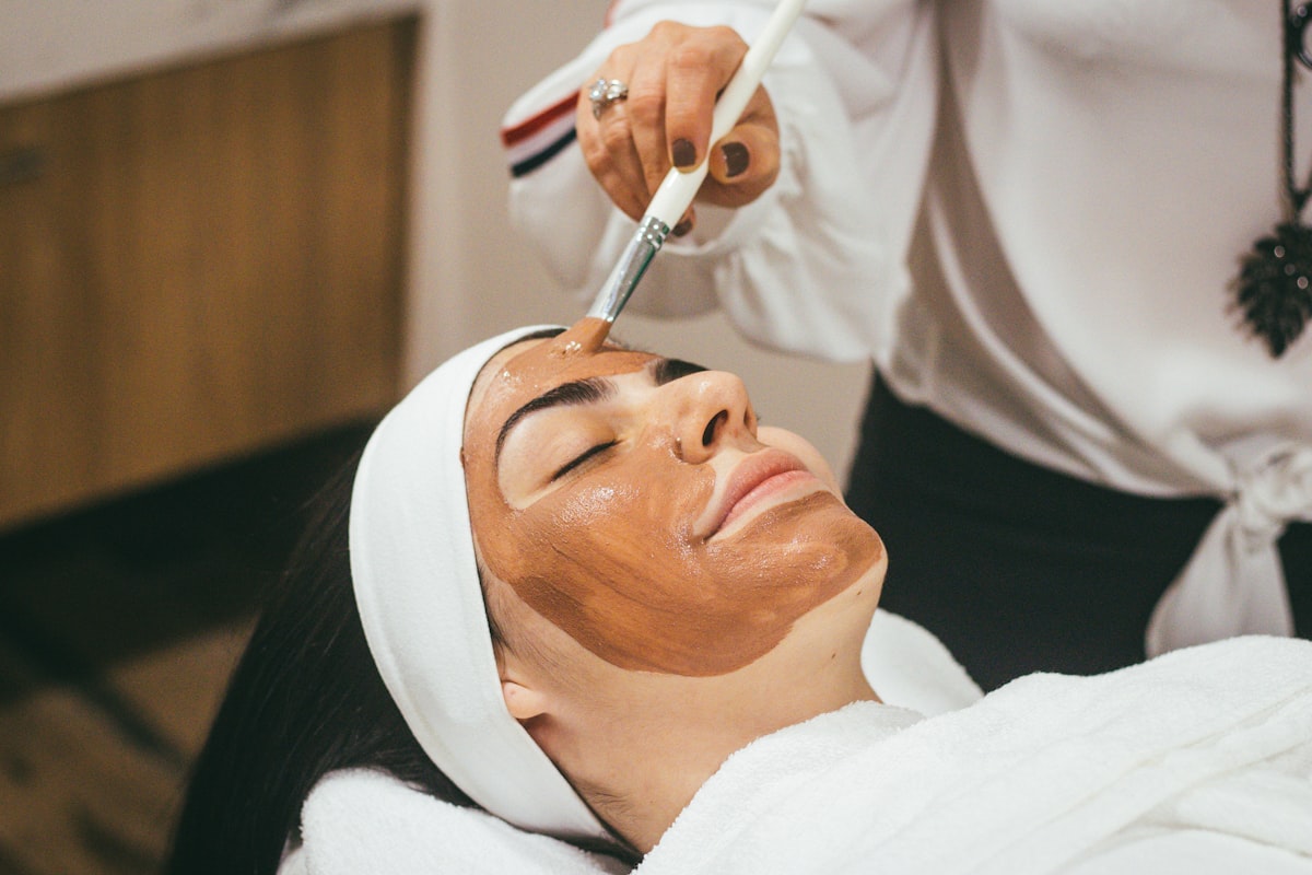 Woman using LED face mask for anti-aging skincare treatment