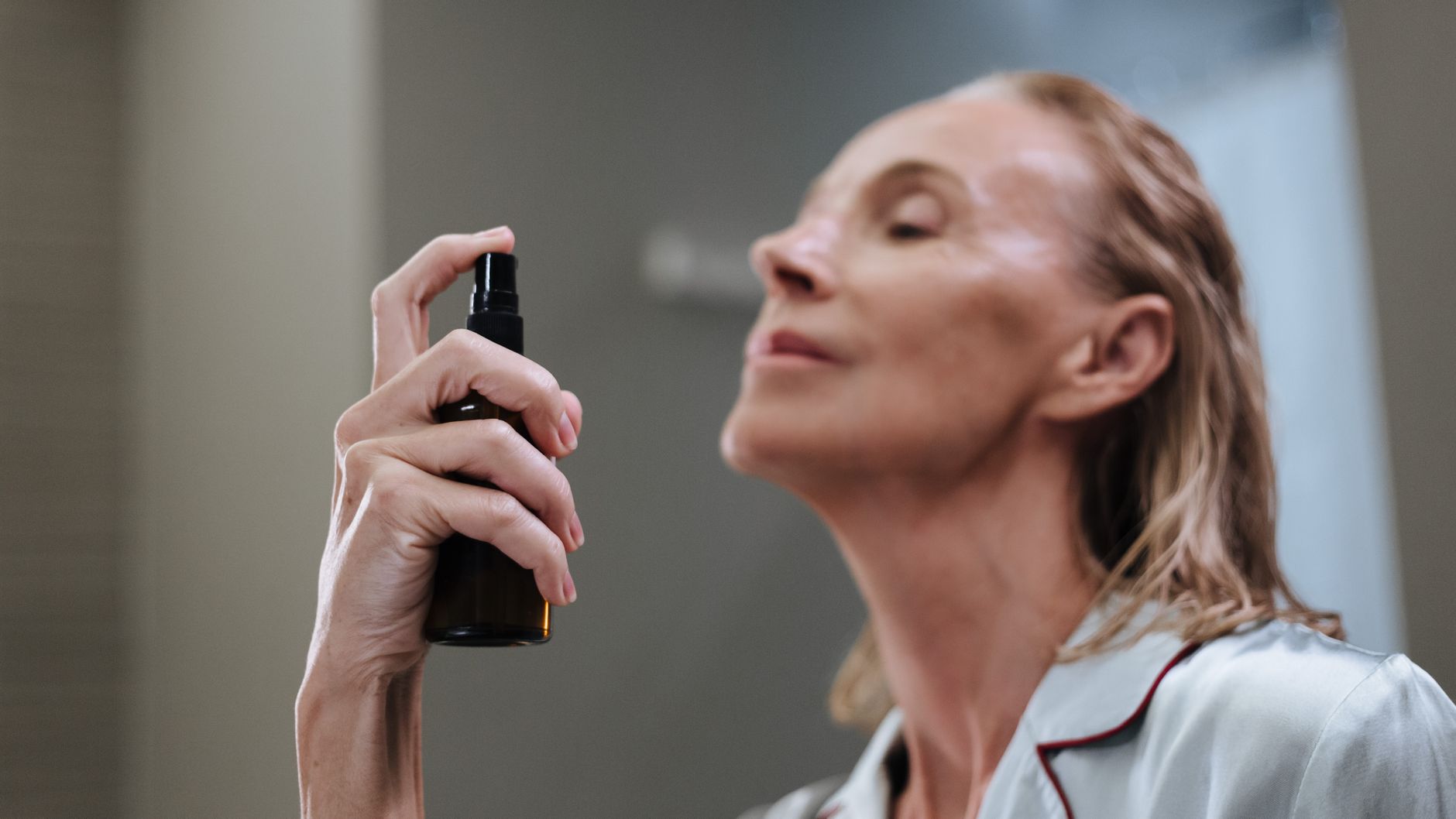 woman using facial mist sprayer skincare